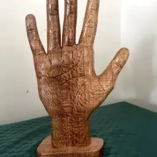 hand-carved wooden hand, art by sari puhakka