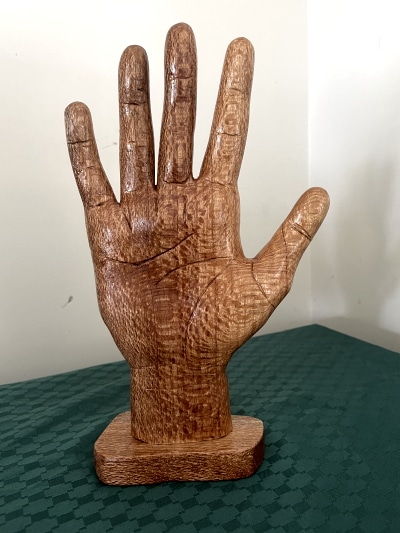Hand carved wooden hand with palm lines